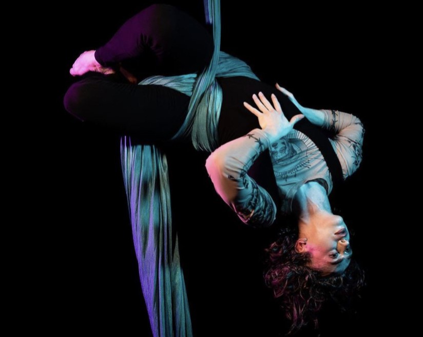 Senior+Cole+Thompson+began+learning+aerial+silk+performance+at+age+14.+In+this+photo%2C+they+performed+in+a+showcase+to+Goldfrapp%E2%80%99s+%E2%80%9CLovely+Head.%E2%80%9D+%E2%80%9CI+love+silks+because+it%E2%80%99s+death+defying%2C%E2%80%9D+Thompson+said.+%E2%80%9CIt+looks+dangerous+and+impossible%2C+and+that%E2%80%99s+beautiful+to+me.%E2%80%9D