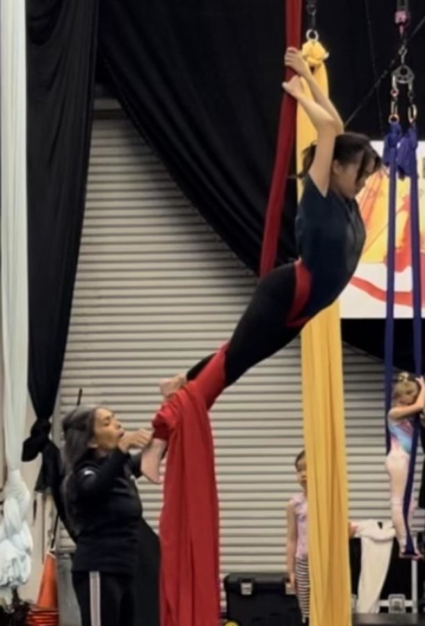 Sophomore Skylar Nguyen has been practicing aerial silk since her freshman year and is continuing to grow her skillset with more difficult movements. “Usually when it comes to doing my drops the first time is always the scariest,” Nguyen said. “Im usually high in the air, so its not like anyone can really, like, help guide my back. Usually though, after practicing it a couple times, I get used to the height and the drop and the technique.”