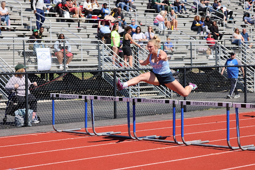 Reaching new heights, Watts sprints the 300 meter hurdles at the 2023 Northwest Invitational track meet. With her best time at 48.27 seconds, Watts qualified for the 2022 MSHSAA Track and Field State Championships and placed 11th as a junior. “My greatest accomplishment is competing at [the state championships]. I remember breaking two personal records at Conference and medaling in all of my events and feeling on top of the world. I knew at that moment that I had a chance to go to state. My favorite track memory is running the 300 hurdles at sectionals and getting fourth, barely making it to state. I remember finishing the race and running toward my hurdles coach [Kat] Briggs and yelling ‘Did I make it? Did I make it?’ She gave me the biggest smile and hug and said I made it to state,” Watts said. 