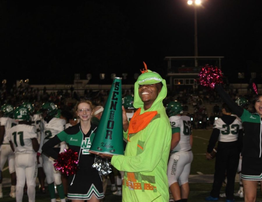 Khylen Murray (12) celebrates the last football game on Oct. 27, 2022. Murray and Alyssa Winston (12) were the only seniors on the 2022-23 football cheer team.