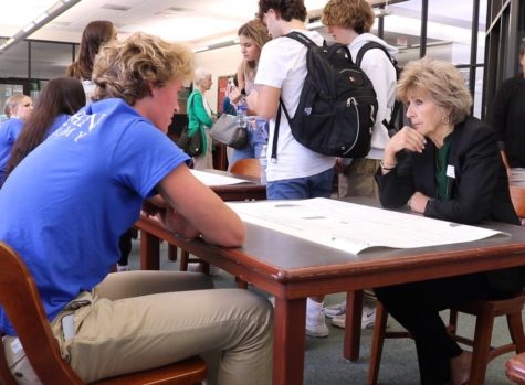 Senior Braden Mohr shares his marine science project with Dr. Pullen. 