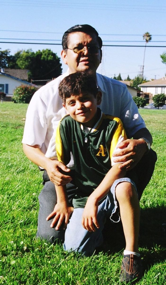 Lopez+at+age+five+in+an+A%E2%80%99s+windbreaker+with+his+grandfather+in+2000.+Photo+courtesy+of+Lopez