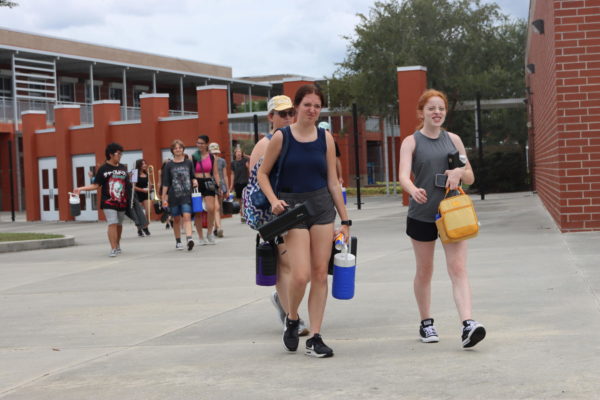 Band students prepare for practice with gallon-size water bottles. Proper hydration is one of the key elements in preventing heat illness. 