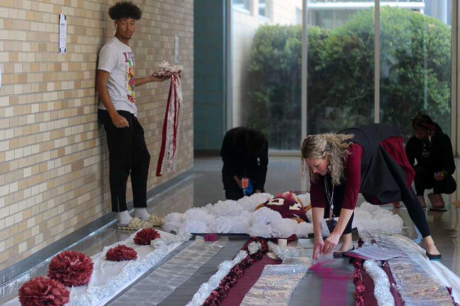Fashion design teacher Abby Winston lays out parts of the mum with her students.
