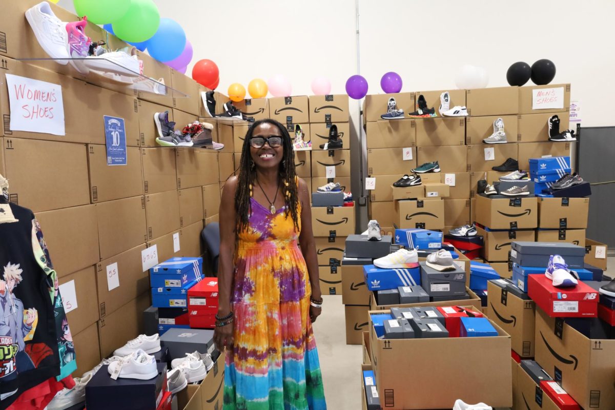 Annette+Patterson%2C+founder+and+Executive+Director+for+the+Joshua+Home%2C+stands+in+front+of+the+massive+display+of+brand+new+shoes+donated+by+Amazon+for+distribution+to+local+LGBTQ%2B+youth.