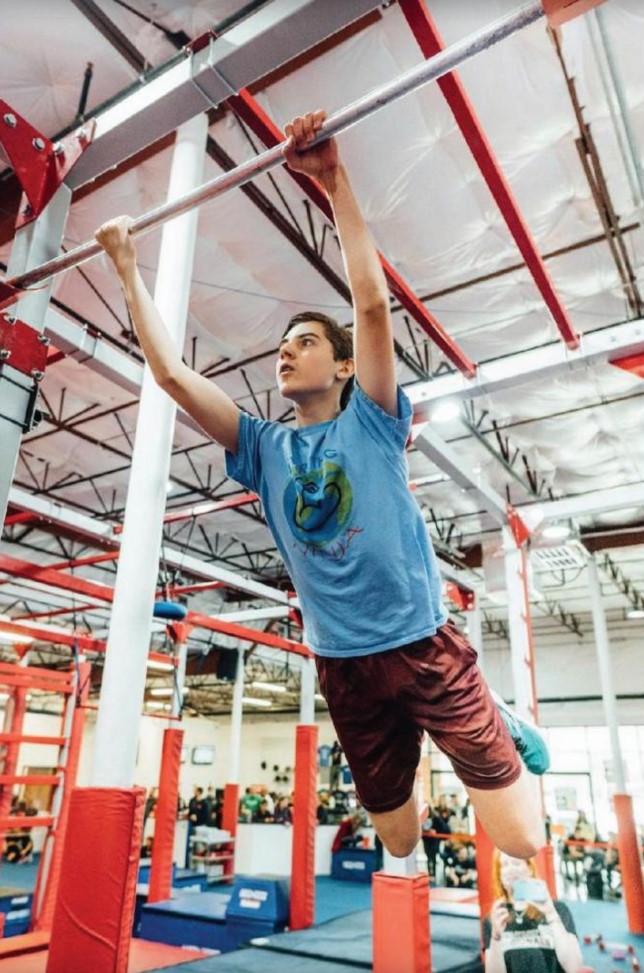 SWINGIN AROUND: Sophomore Jayden White swinging from one bar to another in preparation for his appearance on American Ninja Warrior. White trains most of his time at Move Sport Austin in order to reach his best before his competitions.