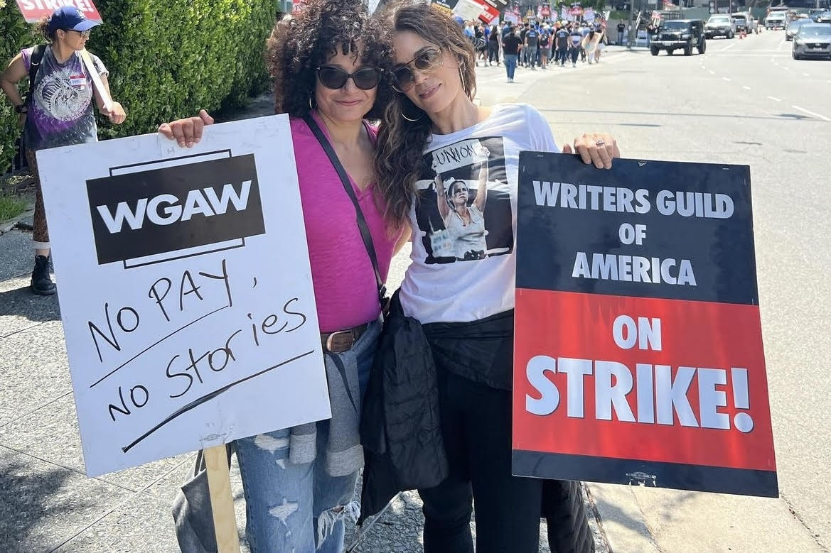 Actresses Judy Reyes and Ana Ortiz picket at the Writers Guild Association strike May 8. Ortiz has been attending WGA and SAG-AFTRA protests almost daily since the start of the unions’ strikes.