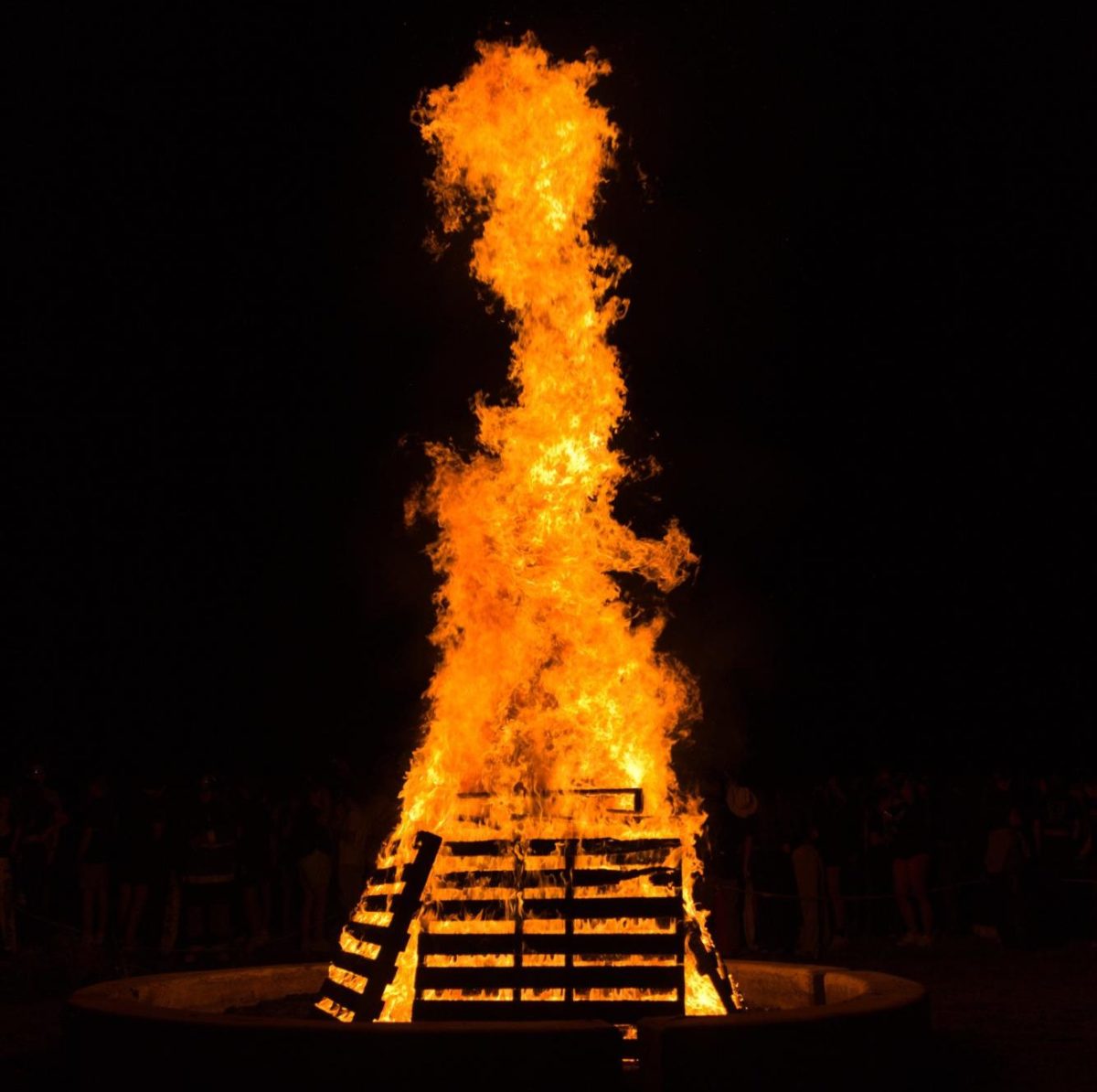 The+Homecoming+Bonfire+burns+in+the+night+Sept.+21.+According+to+Fire+Science%2C+the+fire+was+approximately+25+ft.+high+and+500+degrees+Celsius.+%E2%80%9CThe+Homecoming+Bonfire+is+always+a+cool+tradition+to+be+a+part+of+and+it%E2%80%99s+cool+to+see+the+fire+itself+and+how+high+it+can+get%2C%E2%80%9D+Mason+Conrad+%E2%80%9824+said.