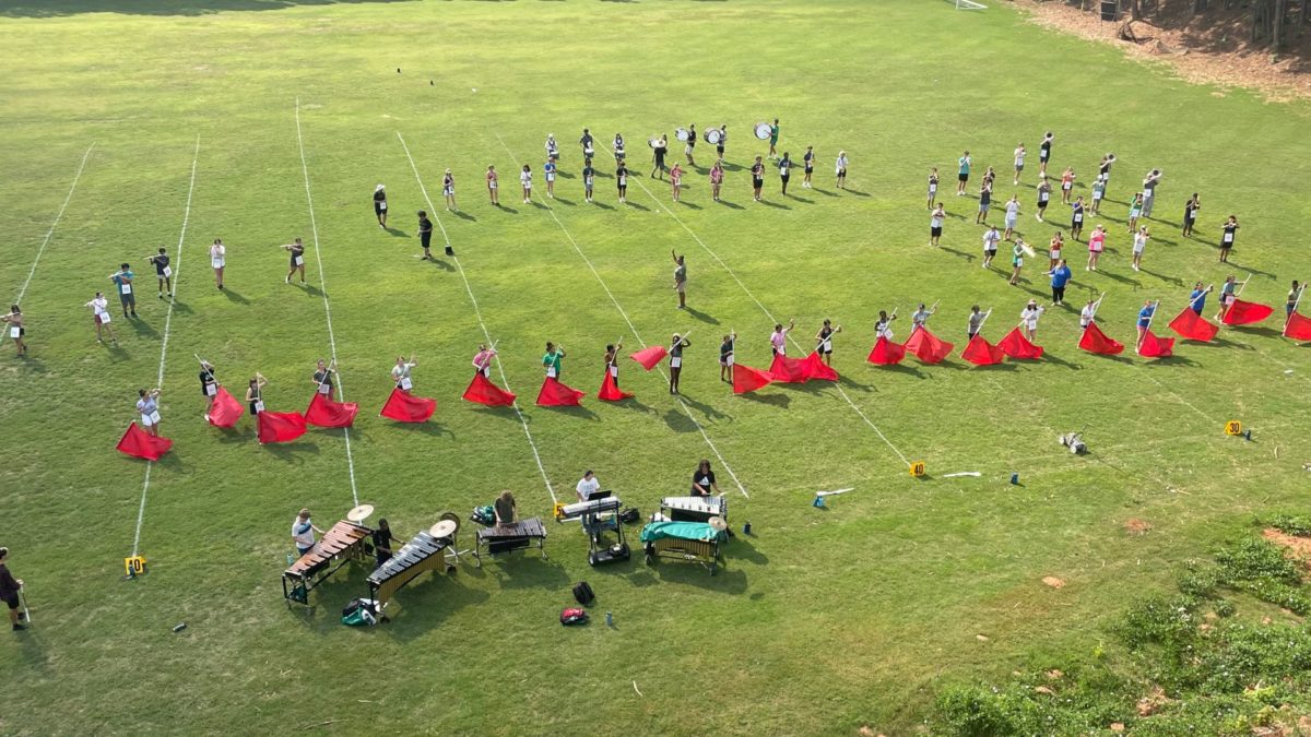 The+view+from+the+tower+of+the+Spirit+of+McIntosh+Marching+Band+practicing+on+what+is+currently+their+practice+field.+Director+of+Bands%2C+Barbara+Baker%2C+center%2C+steps+in+as+backfield+conductor+near+the+50-yard+line+one+afternoon+at+practice+in+Aug..+