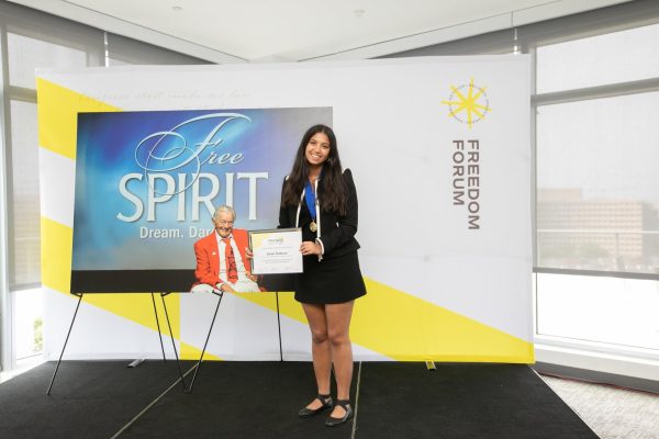 Riana in front of Free Spirit Sign. 