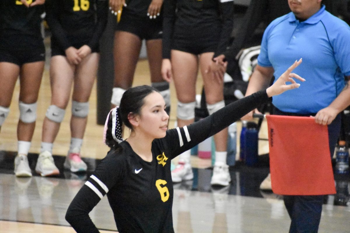 Outside hitter senior Kayla Taylor holds up two fingers during the quarterfinal match against Windward School on Wednesday, Oct. 25.