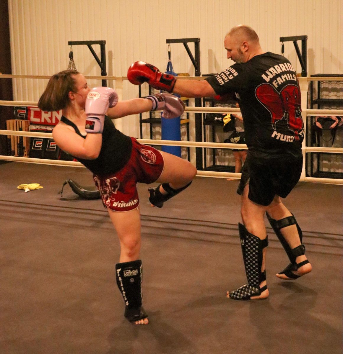 IN COMBAT: Freshman Quinn Loyd spars with her father. Quinn was first introduced to Muay Thai, a form of mixed martial arts originating in Thailand, by her father.