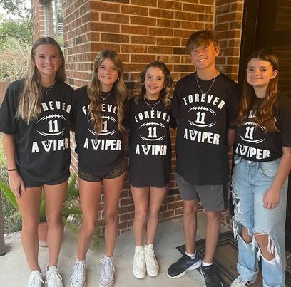 Quintuplets wear matching school spirit t-shirts to football game. The number 11 t-shirts were a node to former player Graylan Spring for the black out football game against Cedar Park.