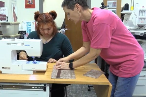 SPED Evaluation Clerk Regina Booth battled breast cancer. One of the greatest tools in her recovery was a pillow to aid her driving. She brought the idea to fashion design teacher Kristi Swinnea, who made it a reality. 