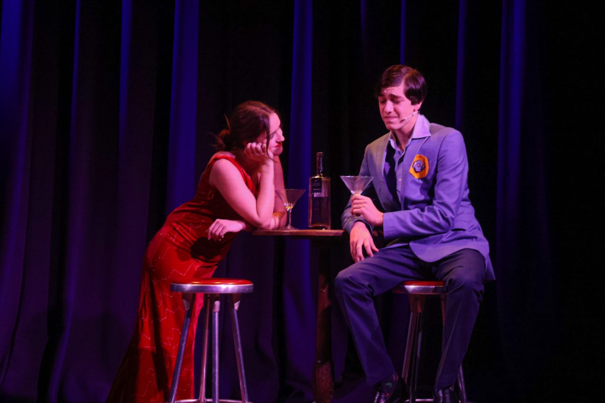 Ziad Ben-Gacem (’25) speaks to Clarisa Gomez Rodriguez (’24) in the show’s opening scene during dress rehearsal Nov. 13. Rodriguez sang the first song of the musical, “I Get a Kick Out of You.”