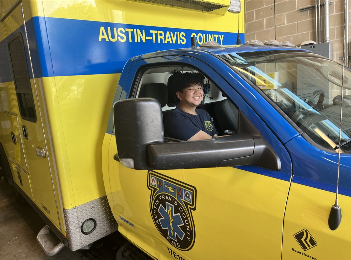 Smiling wide, Benjamin Chang 26 poses proudly for a picture in an EMS truck. An aspiring anesthesiologist, Chang volunteers with the EMS to heighten his passion for medicine.