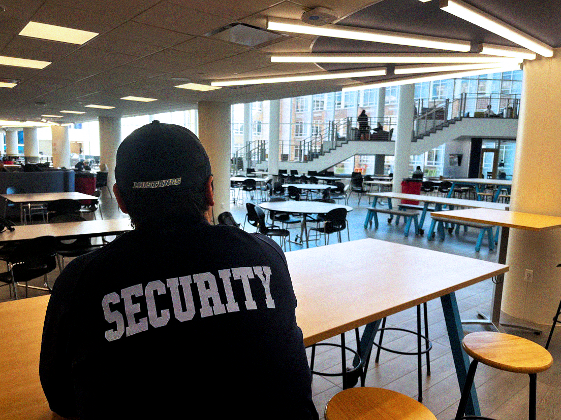 Security+guard+Joshua+Margalus+looks+out+over+the+learning+commons.