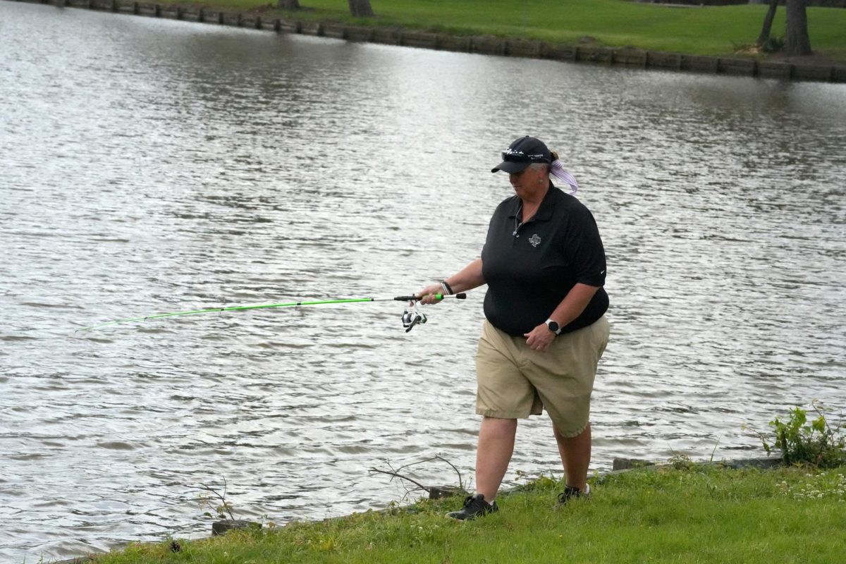 In+breaks+of+action+during+a+spring+golf+tournament%2C+coach+Angela+Chancellor+threw+her+portable+fishing+pole+in+the+ponds+on+the+course.