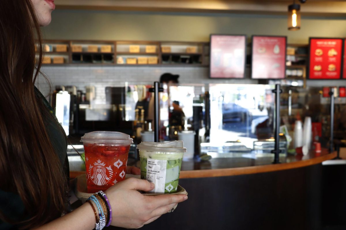 A student waits inside of Starbucks, holding a matcha drink and strawberry refresher. Starbucks is a popular destination across Los Angeles and the U.S. that enables students easy access to caffeine. Teenagers caffeine consumption has greatly increased over the past few years.