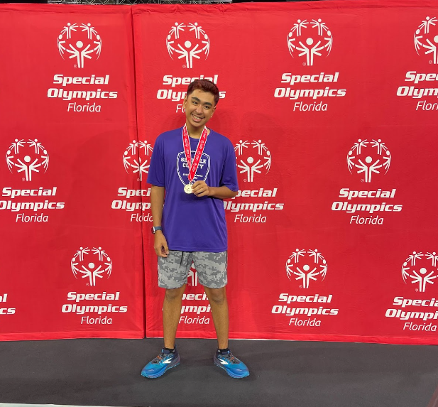 Junior+Bassel+Abualsamid+shows+off+his+Special+Olympics+gold+medal.+Bassel+recently+earned+gold+for+pickleball+at+the+games.