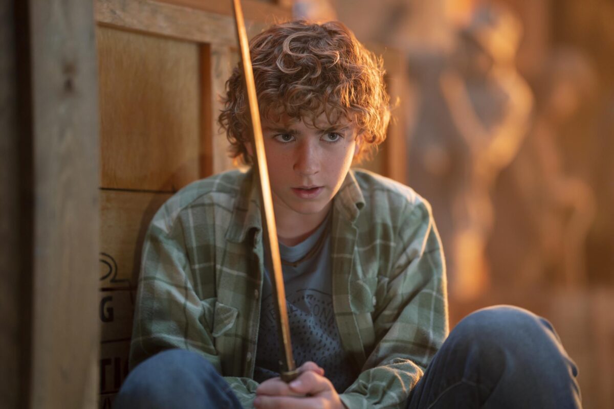Percy Jackson (Walker Scobell, Percy Jackson and the Olympians) holds his mythical sword, Riptide, while hiding behind a box before fighting Medusa in the third episode of the Disney+ series that premiered in December. 