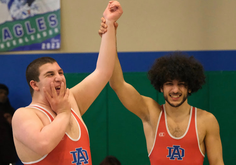 Ali Elshwike (left), celebrates a win against his brother Hamzah Elshwike (right). The unforgettable wrestling match served as a proud moment for both brothers. (Photo courtesy of Chris Waddell)
