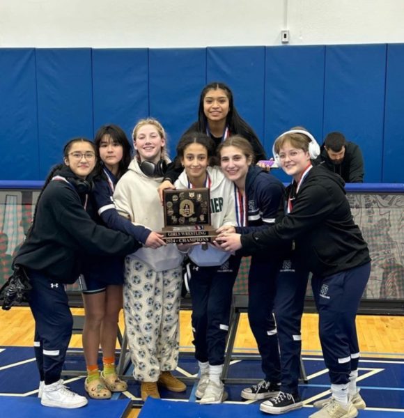 New Trier girls wrestlers celebrate following victory at first official CSL tournament on Jan. 20