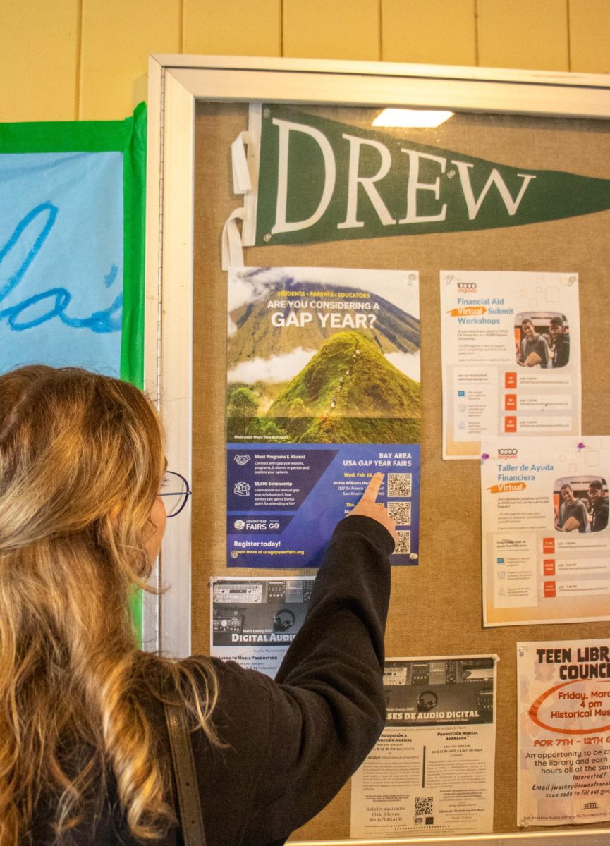 A student looks to the gap year poster in the main hallway outside the counselors office for more information.