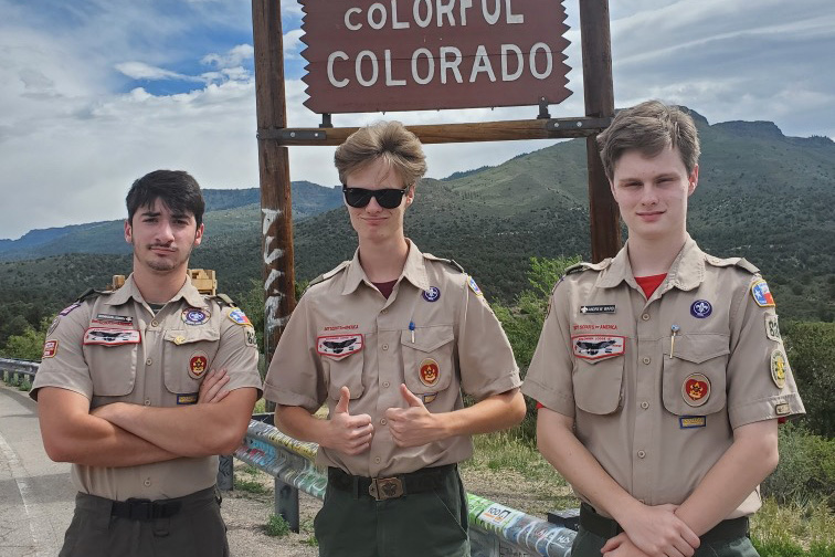 Seniors Forrest Hutchinson, John Ward and Andrew Ward take a photo at the Colorado state line during a trip for the Boy Scouts. Photo submitted by Patricia Hutchinson.