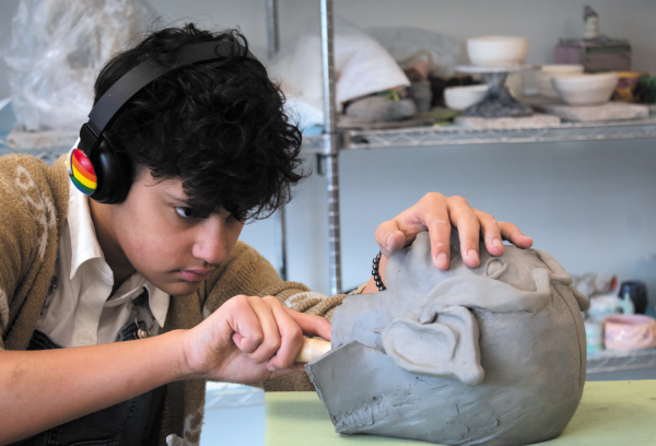 One of the electives Algonquin offers its students is Ceramics. A project they work on in the class is making a bust of a person they choose. In the class, sophomore Axl Whiteman carves the inside of his his sculpture on Jan. 4.