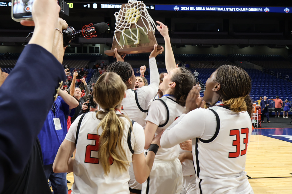 With+the+UIL+5A+state+championship+trophy+in+hand%2C+the+Redhawks+celebrated+their+second+straight+title+at+midcourt+of+the+Alamodome+on+Saturday.+