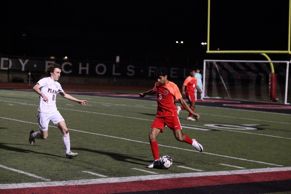 Coppell+senior+left-back+defender+Manav+Kapadia+rushes+past+Plano+sophomore+Cade+Saylor+at+Buddy+Echols+Field+on+Feb.+13.+Kapadia+is+a+varsity+soccer+player%2C+Coppell+Red+Jacket+and+a+National+Merit+finalist.