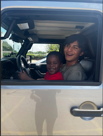 Mateo and I smiling in a jeep after honking the horn multiple times. 