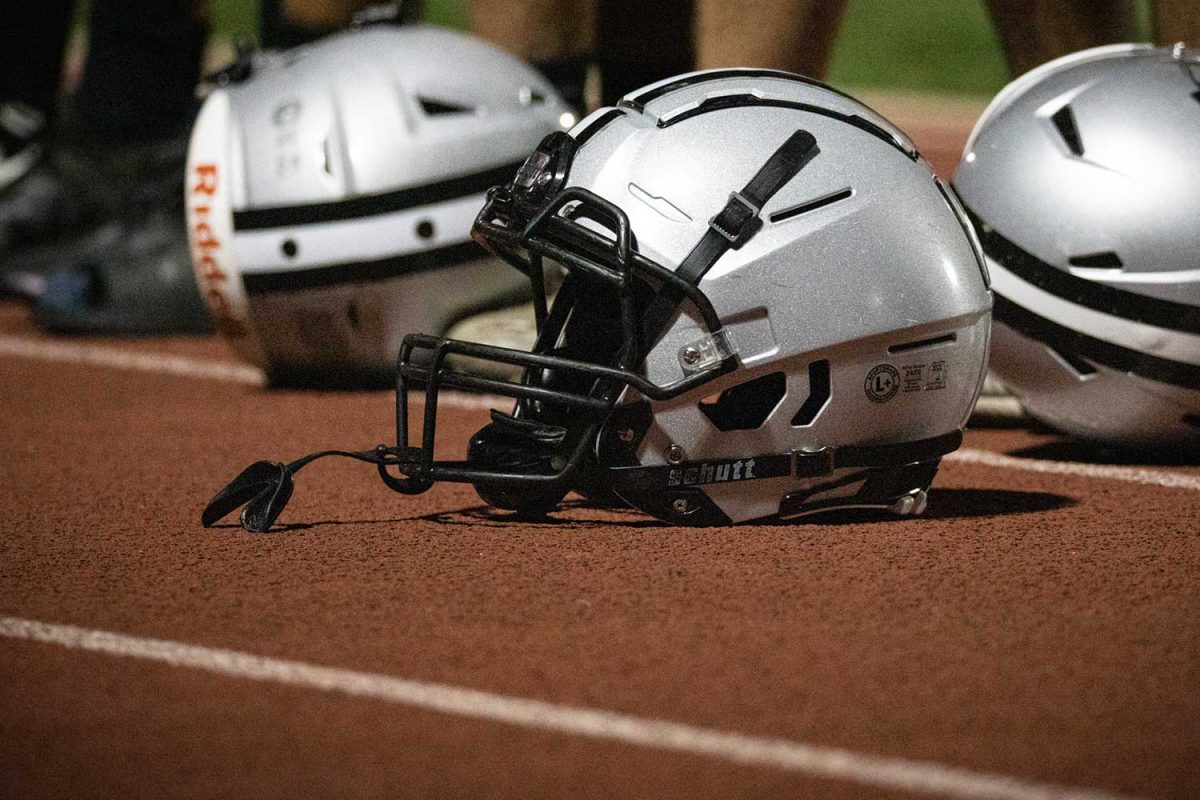 Football helmets rest on the sidelines of a September 9, 2022 game.