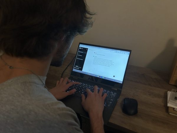 A student writing on their computer