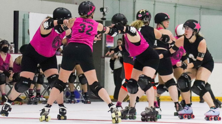 Girls+in+the+Roller+Derby+team+skate+during+a+match.