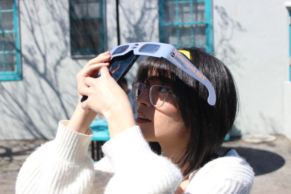 Junior Genesis Cuellar-Figueroa takes a picture of the April 8 eclipse. By using the special eclipse sunglasses, she protected both her eyes and her camera lens. 