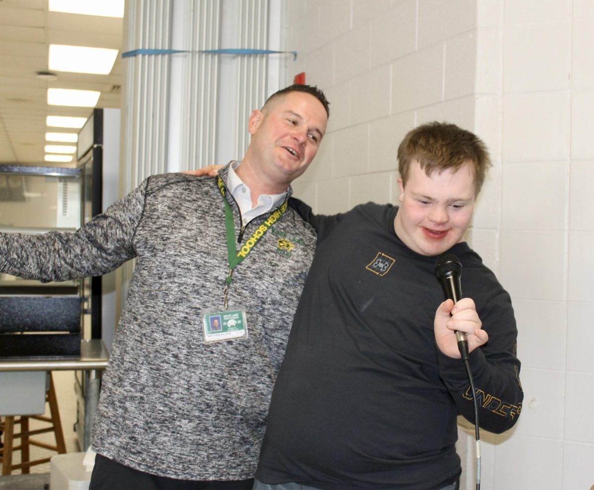 COLUMBIA, MARYLAND, FEBRUARY 20, 2024 -- Ramsey Jenkins, a sixth year ALS student, and Assistant Principal Mr. Sillers sing Be Our Guest, from Disney’s "Beauty and the Beast" at A lunch. Their performances happen daily. Ramsey says singing on the microphone with Mr. Sillers is the best part of his day. 