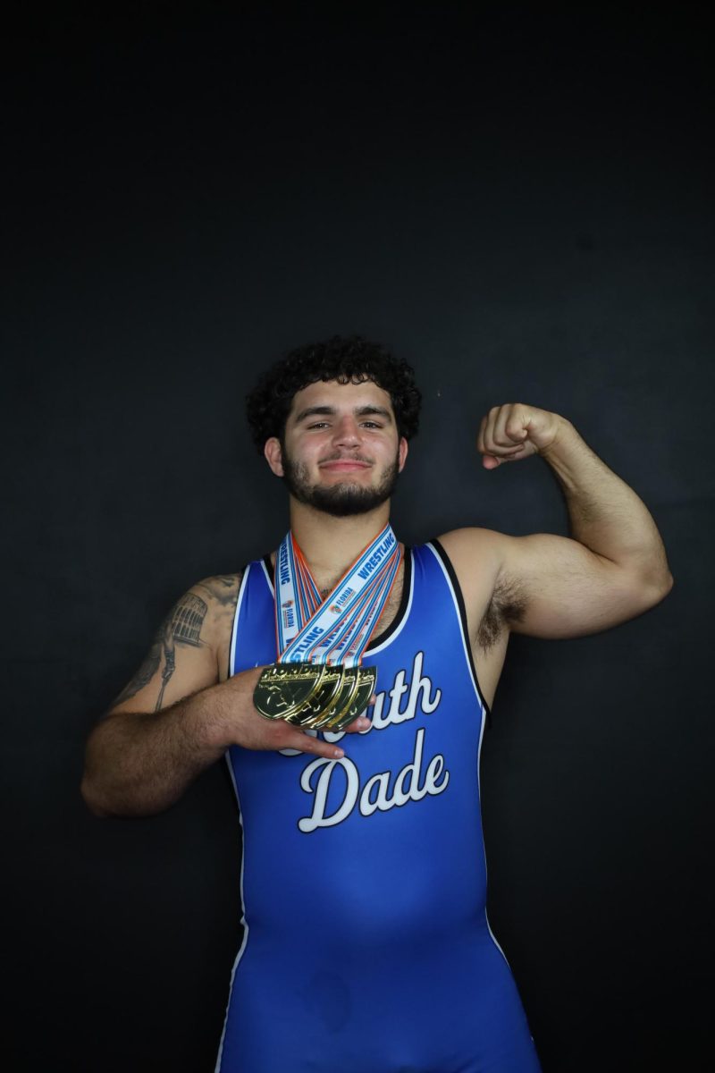 Senior Sawyer Bartelt, 4x state champion, with his state championship medals.