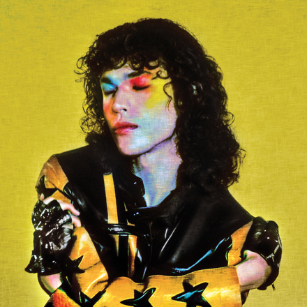 Album cover features Gray in a yellow and black jacket, with a colorful painted face. | Republic Records