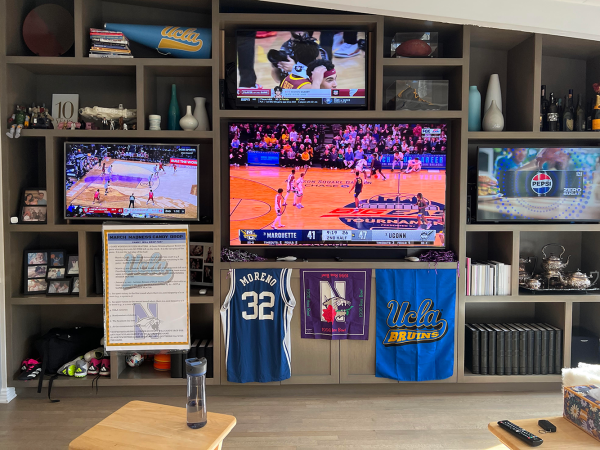 A March Madness set-up displays multiple games and different teams merchandise. This years womens March Madness tournament, which started March 22 and concluded April 8, marked record-breaking viewership. Photo by Rebecca Lazarus.