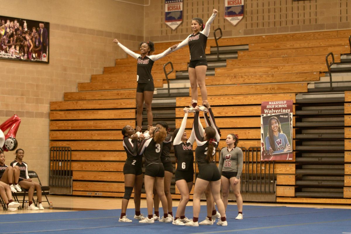 The+flyers+of+the+stunt+team+pose+as+they+are+lifted+off+the+ground+by+their+strong+bases.