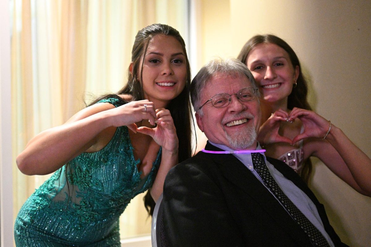 TAHS students Mariyah Hunter and Cami Weyer expressing their affection and appreciation for Mr. McNitt at this years prom. 