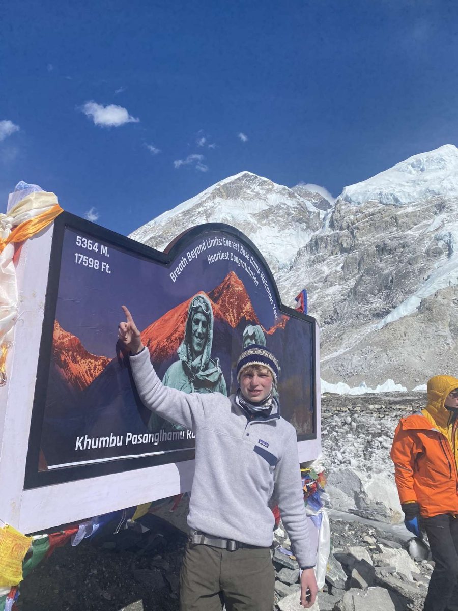 Pointing up to a sign, senior Hudson Addams shows how high in elevation he is. Addams and a few family members traveled to Asia for two weeks to climb to Mount Everest's first base camp. "The best part was being able to look back and see how far we came," Addams said. "Making the climb was honestly the best two weeks of my life and I would do it again in a heartbeat."