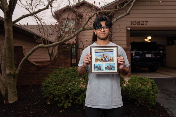Junior Aneesh Patil displays photos of his family on a vacation in Chicago. His family reunited in the U.S. after being apart from his father for a year. “I didnt want to come to U.S. at the beginning [but my sons] were missing their dad,” his mother Anu said. “That was the reason I had to move here.