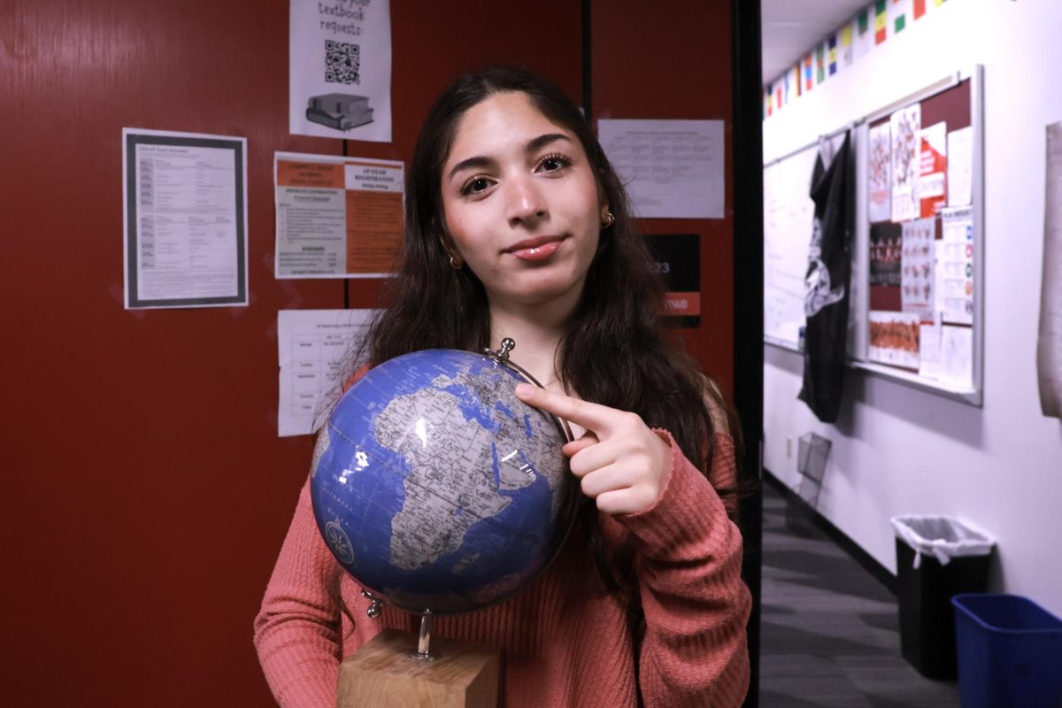 Coppell High School sophomore Maria Saybha points at the world map, tracing the journey that took her from Syria’s turmoil to a new life in America. Saybha has lived in 14 countries, each a waypoint in her quest for safety and stability, all while staying connected to her Arabic heritage.