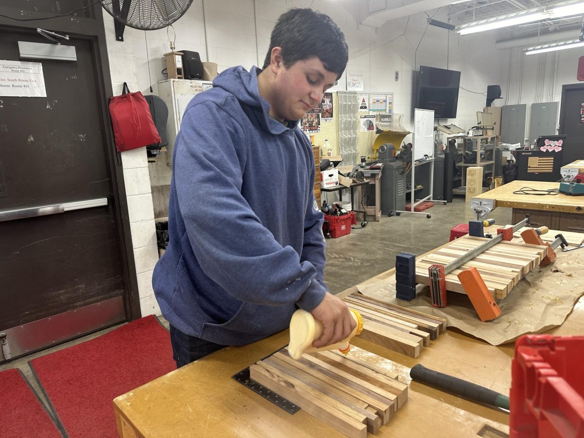 Wesley Royer works in the shop making cutting boards for his trip to Nationals. The boards are hand-crafted and lasered tediously with the ADM Tiger logo. 