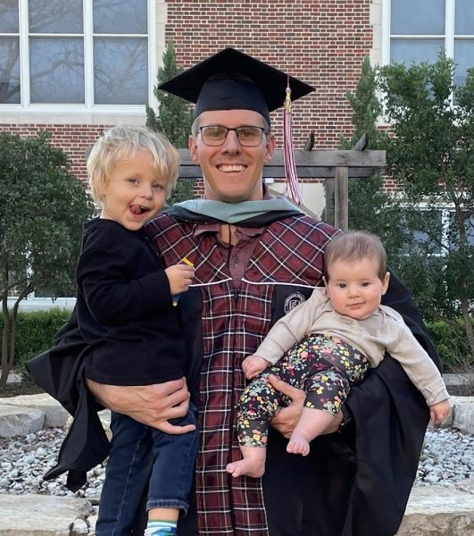 CAP AND GOWN: Babies in hand, government and economics teacher Dalton Pool poses with his family at graduation. For the past couple of months, Pool has been taking courses for a principal certification in hopes of becoming a vice principal in the future. 
