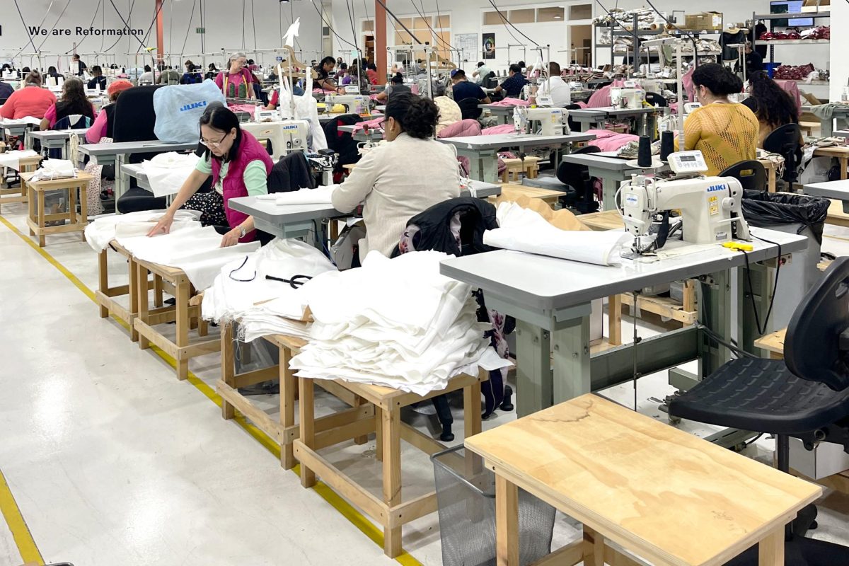 Workers+sew+together+intricate+pieces+of+white+fabric+in+a+production+line+at+Reformations+at+the+original+factory+in+Vernon%2C+California.+In+2020%2C+the+brand+was+awarded+with+a+Sustainability+Quality+Award+of+Excellence+for+Social+Responsibility.+