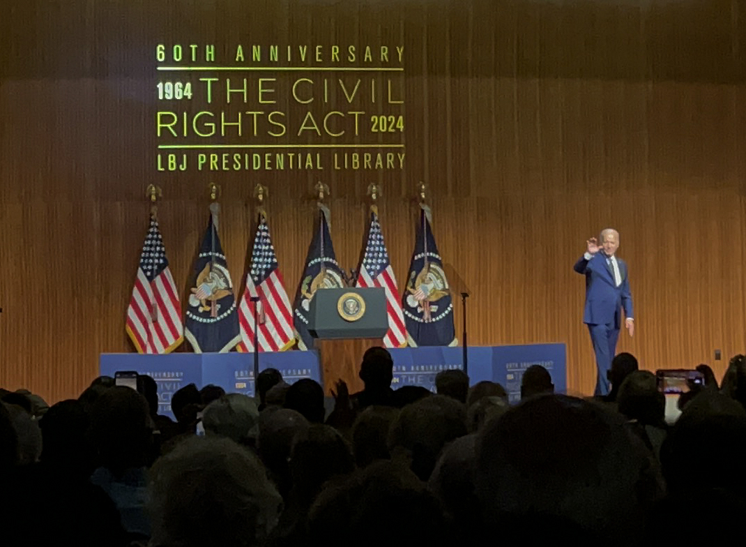 Beyond commemorating the 1964 Civil Rights Act, Biden directed much of his speech to looking forward. He spoke about the importance of understanding that past accomplishments are not the stopping point but rather the foundation from which to keep building. “President Johnson signed the Civil Rights Act of 1964 just two days before the Fourth of July,” Biden said. “He said in that bill signing, and I quote, ‘This is a proud triumph. Yet those who founded our country knew that freedom would be secure only if each generation fought to renew and enlarge its meaning.’” Biden called for a constitutional amendment that would prohibit immunity for crimes a former president committed while in office. “I share our founders’ belief that a president must answer to the law and the president is accountable in the exercise of the great power of the presidency,” he said. “We’re a nation of laws, not kings and dictators.” He also focused his attention on flawed aspects of the Supreme Court, which just granted presidential immunity in Trump v. The United States earlier this summer. Biden stated that term limits and a mandatory code of ethics would create a more balanced power over time. He said that these reforms are needed “to restore trust in the courts and preserve the system of checks and balances that are vital to our democracy.” During his remarks Biden talked directly about his decision to step aside from the 2024 presidential election, as President Johnson did in 1968. Following this decision, Biden endorsed Vice President Harris’ campaign for President and spoke on her ability to continue the work. “She has been an incredible partner to me, a champion of civil rights throughout her career, and she’ll continue to be an inspiring leader and project this very idea of America: the very idea that we’re all created equal and deserve to be treated equally throughout our lives,” he said. “We’ve never fully lived up to that, but we’ve never walked away from it.” Caption by Lillian Gray.